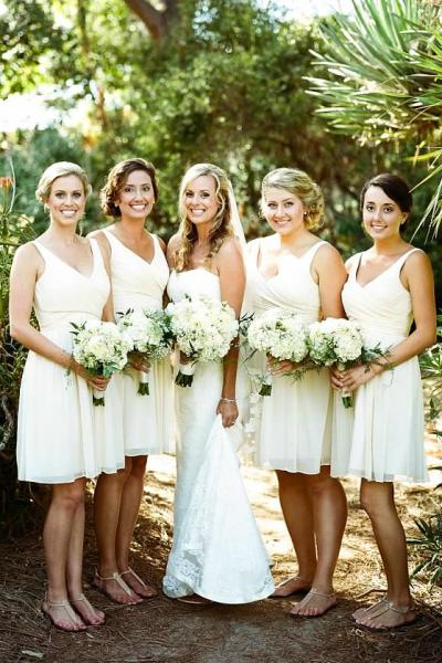 Our charming and stylish bride wears Amy Kuschel's Kennedy wedding dress alongside her bridesmaids. Photography: Allie Lindsey Photography.