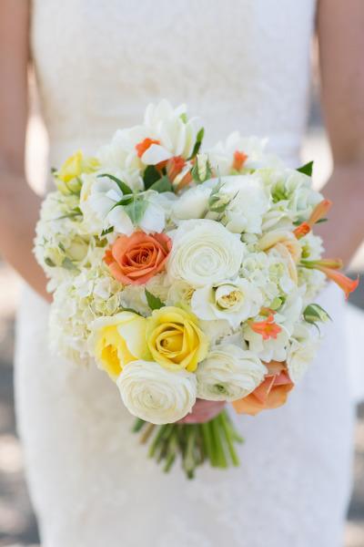 Coral, yellow, cream wedding bouquet. Bride wears Amy Kuschel's Kennedy wedding gown. Photo credit: Sabine Scherer Photography.