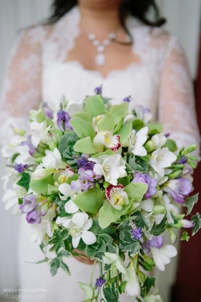 Gorgeous bridal bouquet! Bride wears Amy Kuschel's Rosemary wedding gown and long sleeve lace shrug. Photography: DOLA Photography.