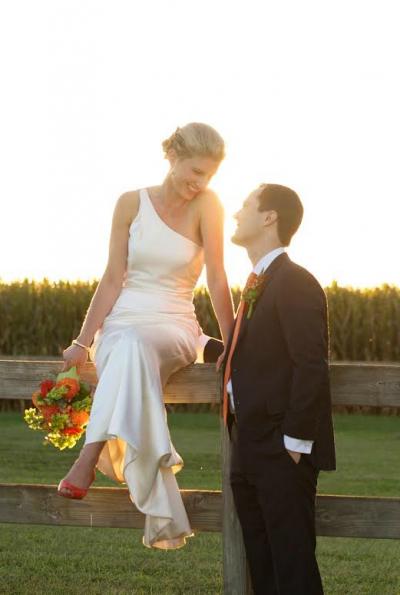 Amy Kuschel's one-shoulder sheath silhouette wedding gown, Liberty, gives Hollis a polished modern look.