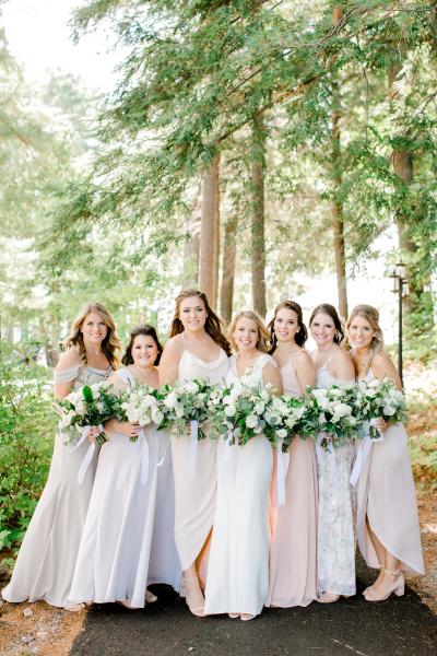 Beautiful bride in Amy Kuschel's Calistoga wedding dress with blushing bridesmaids, photo by Kayla Yestal