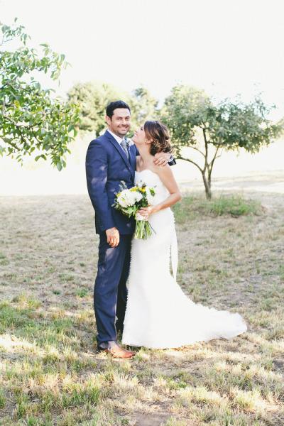 Jessica loves Chad! The bride wears Amy Kuschel's Voila! wedding gown. Photo courtesy of onelove photography.