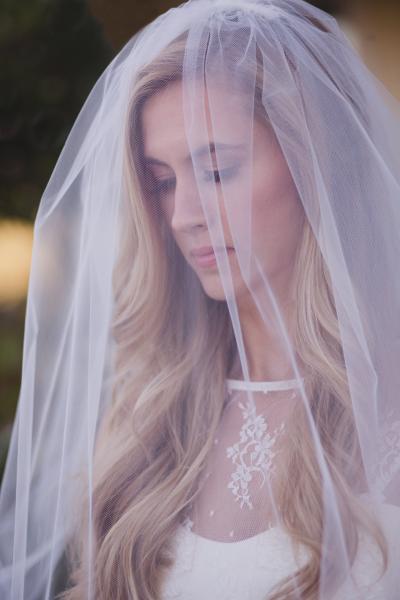 Monroe's sheer lace bateau neckline sets the stage for romance. Wedding dress by Amy Kuschel. Photography: Gina Brocker Photography.