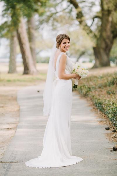 The bride exudes 1920's charm with a measure of Grecian romance in Amy Kuschel's Sloane wedding dress. Photography: Lindsey A Miller Photography.