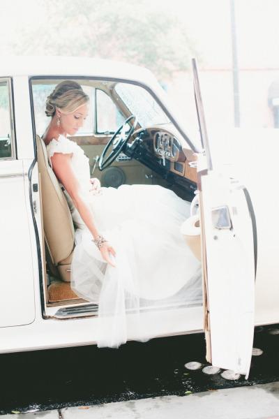 Amy Kuschel's Sabrina "Takes the Plunge" gown shown with Classy Chassis' vintage car. Photo courtesy of Onelove Photography. As seen on Style Me Pretty.