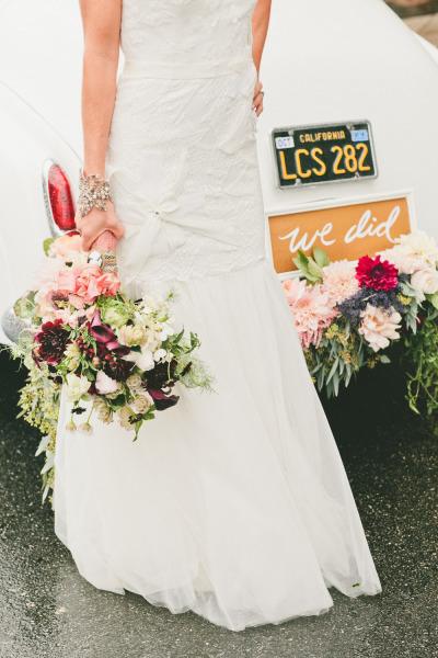 Amy Kuschel's Sabrina "Takes the Plunge" gown shown with Classy Chassis' vintage car and Floral by Seed Floral. Photo courtesy of Onelove Photography. As seen on Style Me Pretty.