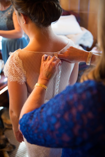 Button back details of Starr, an Amy Kuschel lace wedding gown made in San Francisco. 