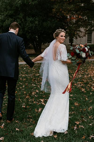 Beautiful bride in Amy Kuschel's Malibu wedding gown with custom flutter sleeve. Photo: Ash Carr Photography